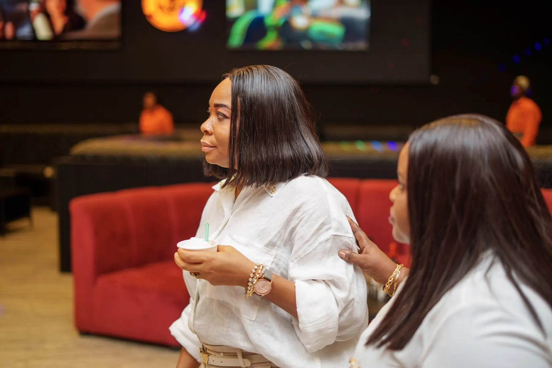 Two guests in white chatting in the lounge
